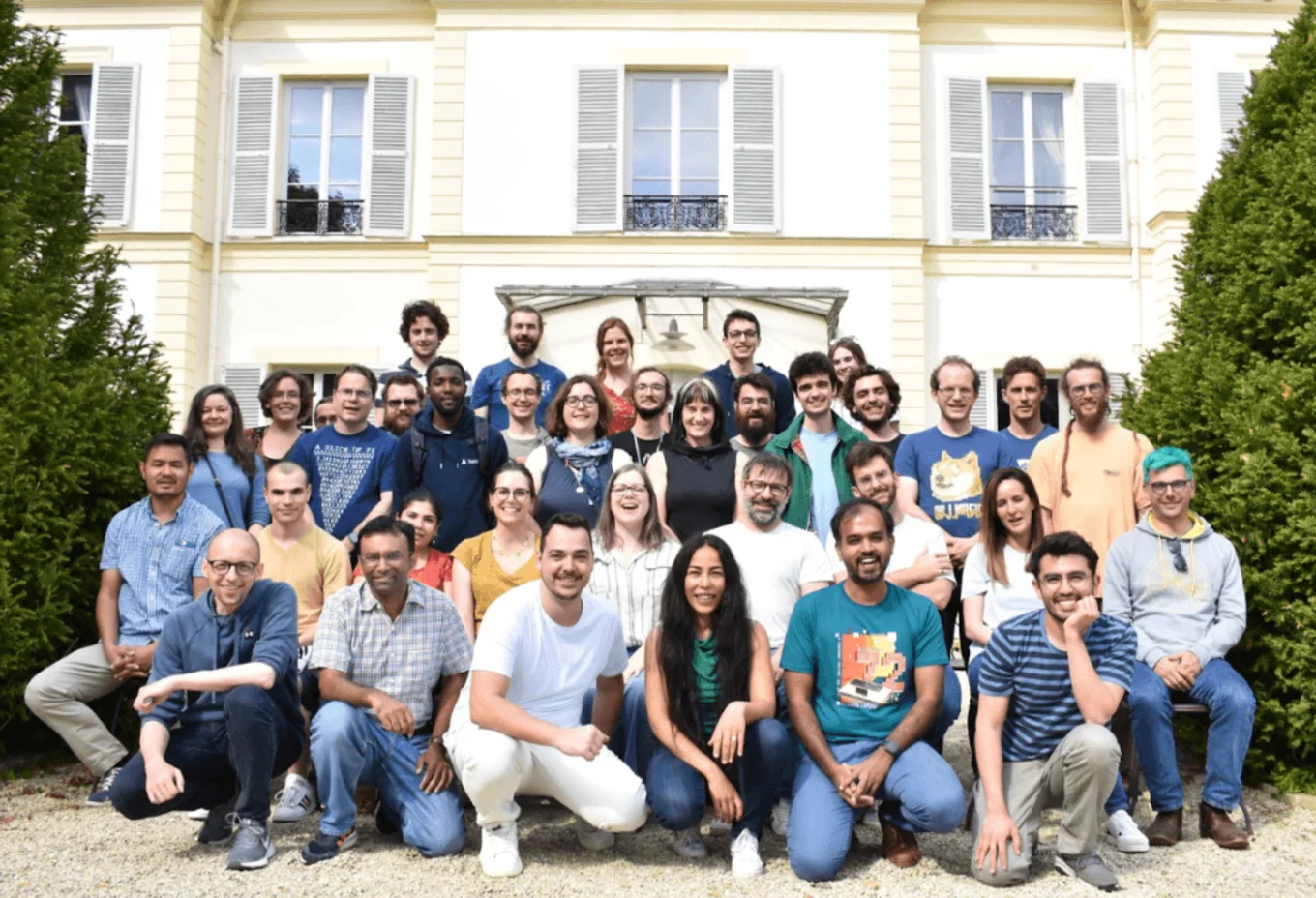 A group of people posing in front of a building.